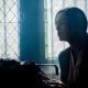 Image of a woman ghostwriter in a dark room at a typewriter providing ghostwriting services